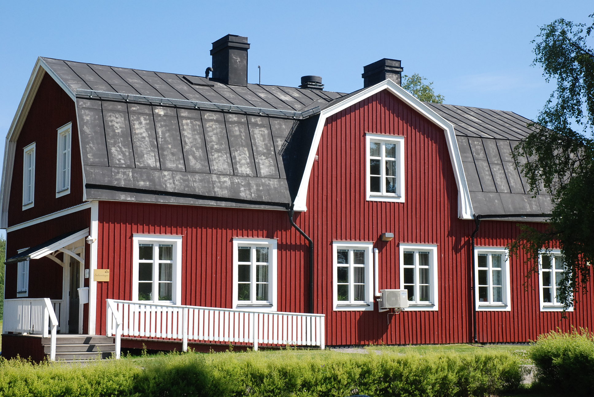 Boteå sockenstuga. Rött trähus med vita knutar.