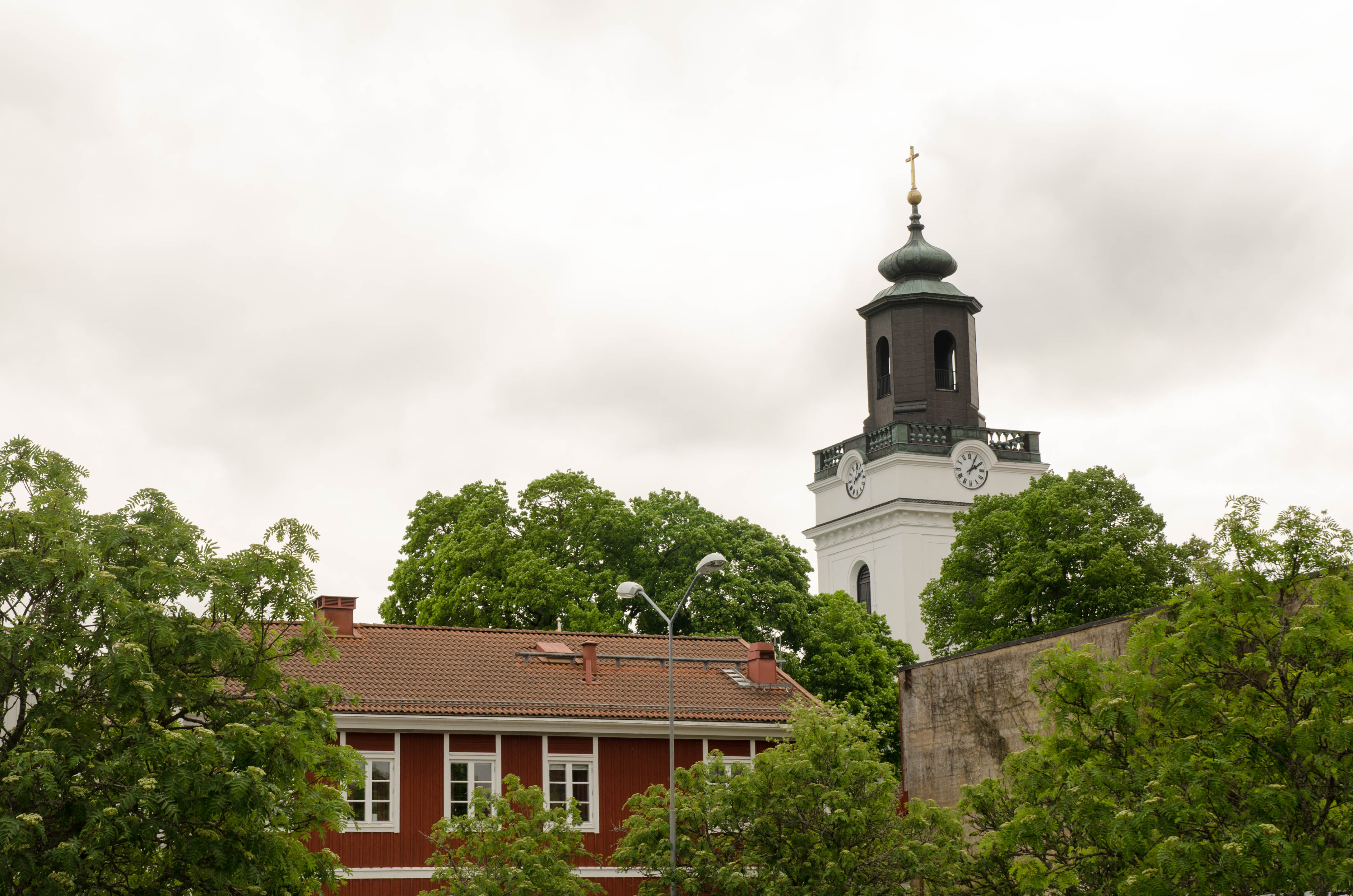 Eksjö kyrkas torn med Kyrkbacksgården framför.
