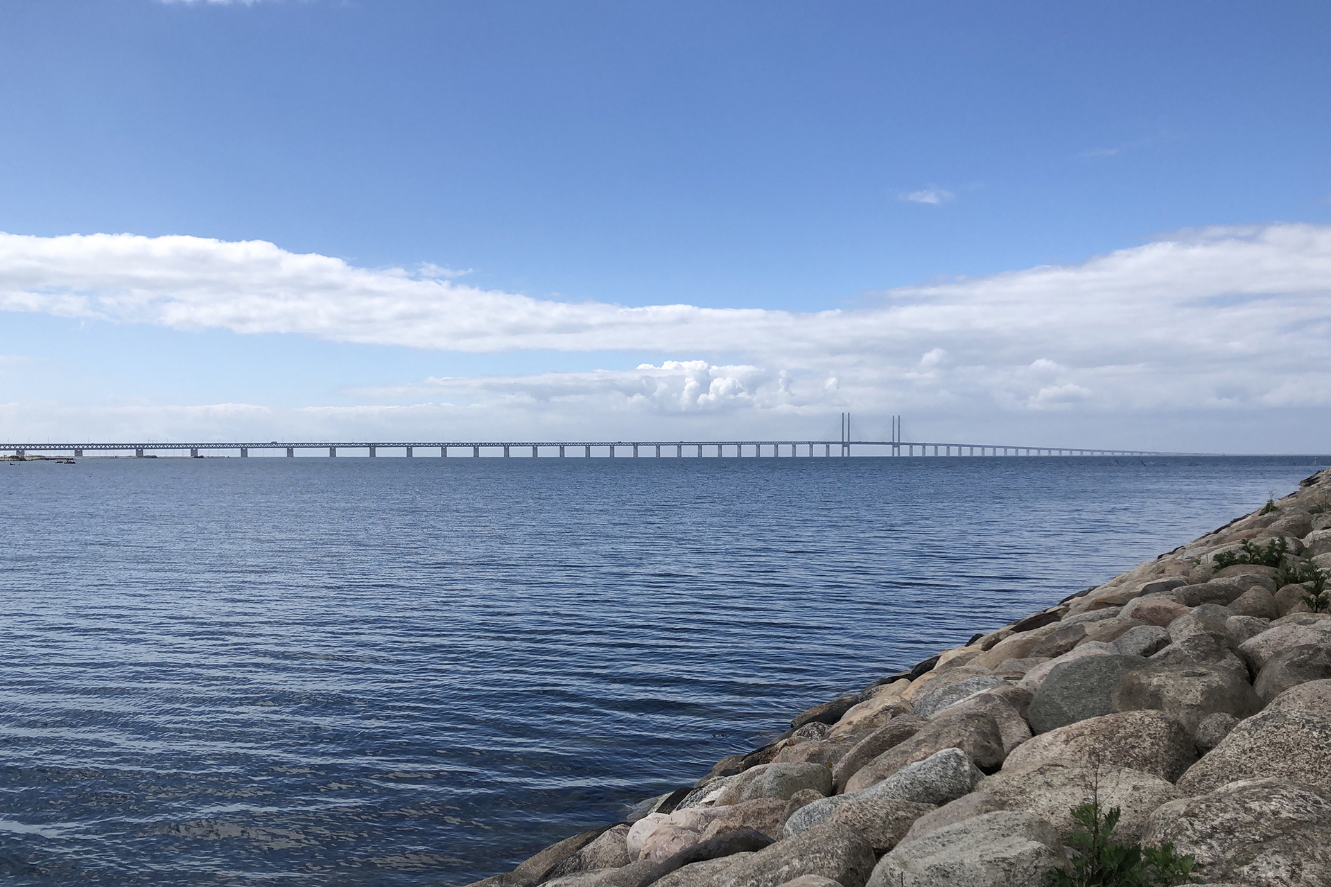 Öresundsbron maj 2020 med vågbrytare i sten i förgrunden