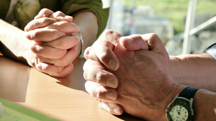 Två personer som ber tillsammans