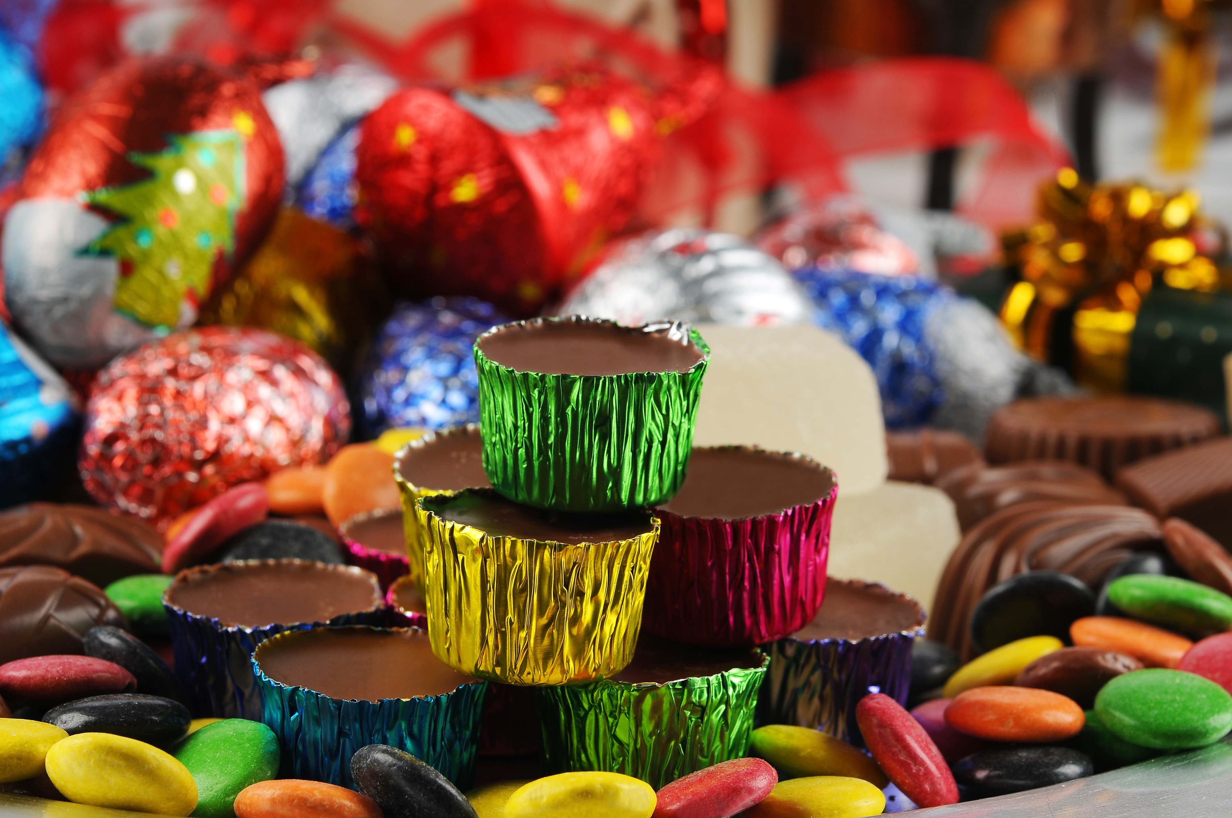 Ischoklad i färgade aluminiumformar, chokladbitar och annat julgodis.