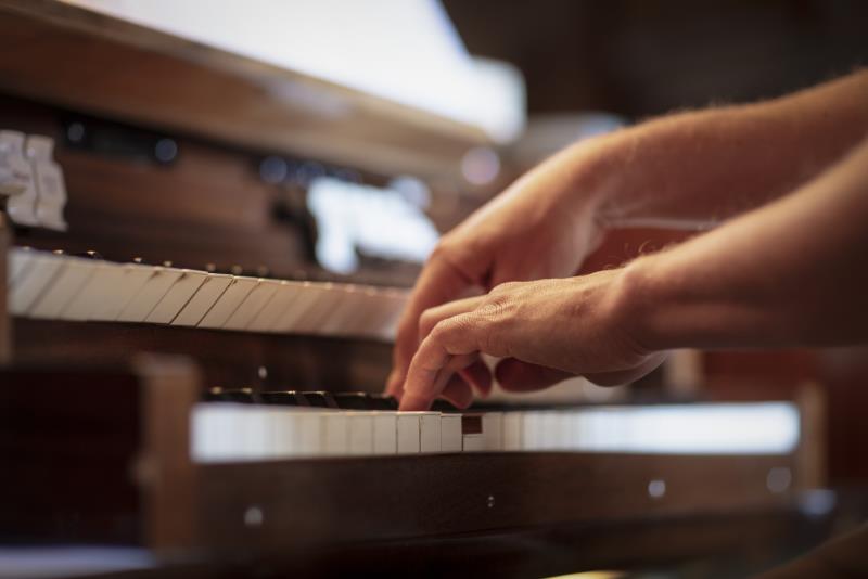 Närbild på någon som spelar orgel.